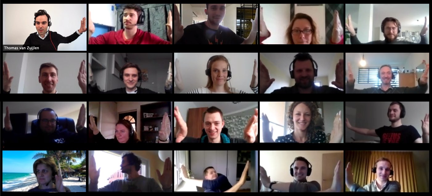 People in a video call joining hands for the camera